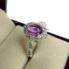 Dainty Natural Amethyst Ring - Cabochon Ring - CZ Diamonds Ring - 925 Sterling silver - Beautiful Amethyst And Zircon Jewelry - Prong Ring Specifications :- ❥ Stone - Natural Amethyst ❥ Stone Size - 6x8mm  ❥ Cut Type - Oval Cabochon ❥ Side Stones- Simulated diamonds Cz ❥ Ring Size: I offer more than one (Contact us if your ring size is not available in the listing) ❥ Color: Silver, Gold, Rose Gold, White Gold or Black Rhodium ❥ Material : 925 Sterling Silver, 14K/18K/22K Solid Gold --> ❥ Makes a Prong Ring, Smoky Quartz Ring, Purple Amethyst Ring, Zircon Jewelry, Amethyst Gem, Red Jewelry, Diamonds Ring, Cabochon Ring, Cz Ring