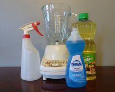 three different types of cleaning products sitting on a table next to bottles and blenders