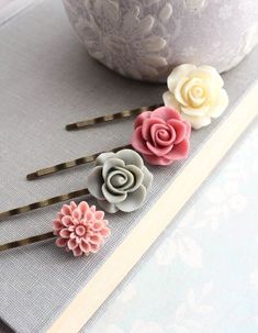 This is a beautiful collection of four resin floral bobby pins! These hair pins are pretty and modern hair accessories. Included in this set of four bobby pins is one ivory cream rose, one dusty rose pink rose, one sage green grey rose and one dusty rose pink dahlia! You will love these fun whimsical hair pins! This is a set of hair pins set on antique brass bobby pins. Total length is approximately 2.5 inches (6.5 cm) Please contact me anytime with any questions or with custom request.... To se Flower For Hair, Whimsical Hair, Rose Hair Clip, Pink Dahlia, Long Silver Earrings, Hair Gift, Silver Flower Earrings, Dusty Rose Pink, Bridemaids Gifts