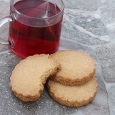 some cookies are next to a cup of tea