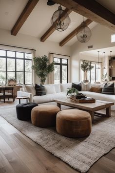 a living room filled with lots of furniture next to a wooden floor covered in windows