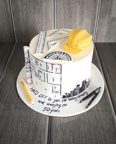 a cake that is sitting on top of a white plate with writing and construction themed icing