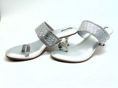 From our newest collection, A gorgeously crafted silver wedge with a toe ring strap set with silver colored crystals and a center strap intricately adorned with silver crystals and crystal rectangles. The padded base makes it comfortable to wear for extended periods of time. With 2 inches heels these are cozy enough to wear out on a date, to dinner, or for any other special event. For a larger selection of the shoes we sell, visit our page. We send packages to you promptly and well packaged for a safe journey. We appreciate your help with our small business. shipped from the USA. sizes offered: US 6, 7, 8, 9, and 10 Elegant Crystal Sandals With Bling, Silver Open Toe Sandals With Rhinestones, Elegant Silver Sandals With Crystal, Silver Rhinestone Toe Post Sandals, Silver Toe Post Sandals With Rhinestones, Silver Crystal Sandals, Silver Crystal Open Toe Heels, Silver Toe Ring Sandals, Silver Toe Ring Sandals For Wedding