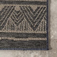 a blue and beige area rug on the floor