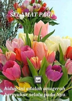 two vases filled with colorful tulips on top of a table next to each other