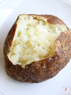 a close up of a baked potato on a plate