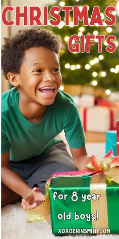 a young boy sitting next to a christmas present