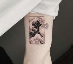 the great wave tattoo on the left arm