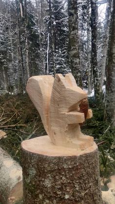 a tree stump with a carved bear head on it