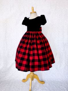 An elegant dress that's perfect for any occasion: wedding, christmas, birthday, or pageant! This dress is made out of a comfortable cotton plaid bottom and velvet top. The top comes with short sleeves and a zipper on the back. Attached to the waist are two strips of plaid fabric that can be used to tie together into a bow at the back for a comfortable and snug fit. The plaid skirt has a layer of layer of lining with crinoline attached to give the skirt some fullness. *Mannequin has petticoat to Fitted Princess Dress For Christmas Birthday, Fitted Princess Dress For Christmas Dress-up, Winter Party Princess Dress Fitted, Short Sleeve Christmas Wedding Dress, Elegant Winter Holiday Princess Dress, Elegant Holiday Dress For Birthday, Fitted Christmas Dress For Dress-up Occasions, Fitted Winter Holiday Princess Dress, Holiday Princess Dress For Dress-up