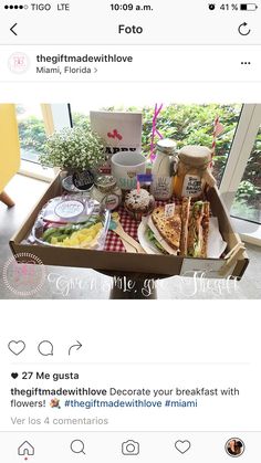 a box filled with food sitting on top of a table next to a window in a room