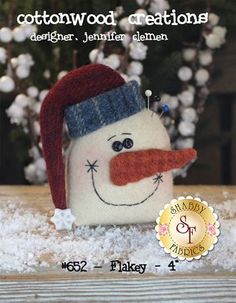 a small snowman with a red hat and nose