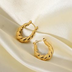 Revitalize your style with Twisted Hoop Earrings, exquisitely fashioned in 18k gold plating. These earrings feature an alluring twisted design, adding a modern flair to the classic hoop, perfect for a sophisticated, fashion-forward look. Twisted Gold Plated Hoop Earrings, Elegant Twisted Hoop Earrings Gift, Elegant Twisted Hoop Earrings, Modern Twist Gold Plated Hoop Earrings, Elegant Twisted Metal Hoop Earrings, Modern Twist Gold-plated Hoop Earrings, Elegant Twisted Tarnish-resistant Hoop Earrings, Gold Plated Hoop Earrings With A Modern Twist, Chic Twisted Hoop Earrings