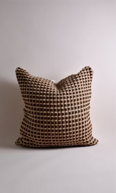 a brown pillow sitting on top of a white table