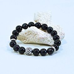 Contemporary gemstone stretch bracelet, featuring polished black agate beads and a silver accents. Minimalist and classic. Wear alone or stack with other stretch bracelets. This bracelet is suitable for men or women, for meditation, grounding or just to look good. It would make a great gift for any season or any reason. * 10 mm banded agate beads  * Metal alloy bead with intricate carving * Double-strung with high-quality elastic (latex-free) * Custom made to your size & design specification - s Black Agate Crystal Bracelet For Gift, Black Agate Bohemian Bracelets, Black Agate Crystal Bracelet With 8mm Beads, Black Agate Bracelet With 8mm Beads, Spiritual Black Agate Bracelets, Intricate Carving, Classic Wear, Long Dangle Earrings, Agate Bracelet