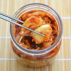 a glass jar filled with food on top of a table