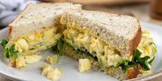 an egg salad sandwich cut in half on a plate