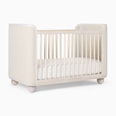 a white crib with no mattress in it