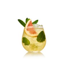 a glass filled with lemonade and mint garnish on top of a white surface