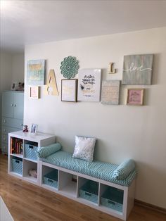 a white wall with some blue and white items on it's display shelf next to a bookshelf