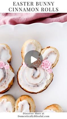 an easter bunny cinnamon roll with icing on it and pink flowers in the middle