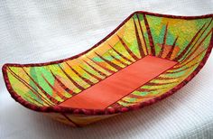 a colorful bowl is sitting on a white surface