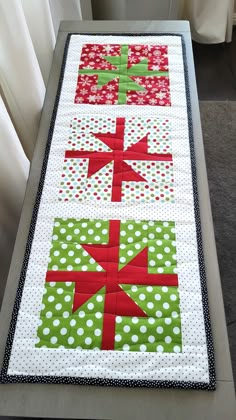 Christmas parties are more festive with this adorable Christmas reversible quilted tablerunner.  Great hostess gift idea, dining table decor, side table decor, Christmas party decor, guest room decor or can be hung for wall art. The holiday Christmas packages feature snowflakes and polka dots in red, green and white and scampering mice with Santa hats on the reverse side.  Measures 32" x 12" and features hand-stitched binding for an elegant look. Made of 100% cotton with a cotton/polyester blend batting. Spot cleaning is recommended to maintain the integrity of the table runner. Since it is made of 100% cotton, it will shrink some upon washing. If necessary, wash in cold water on gentle cycle, air dry, and press with a cool/warm iron. Speedy, free shipping in a box! Thank you for stopping Xmas Table Runners Quilted, Christmas Runners Table, Runner Christmas Gifts, Quilted Runners, Christmas Decor Table, Quilted Christmas Gifts, Xmas Table Runners, Christmas Packages