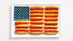 hot dogs, ketchup, and mustard or cheese on a plate with the american flag