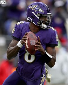 a football player holding a ball in his hands