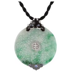 Simply Beautiful! Featuring a Stunning Vintage Hand Carved Jade Disc, enhanced by Diamonds, Sapphires. Hand crafted 18K White Gold Pendant suspended from a Silk cord. Green Jade (A-grade), untreated, "Py Stone" disc diameter measures approx. 55 mm. 2 untreated Black Nephrite Fancy elements; 50 round Brilliant cut Diamonds, weighing approx. 0.30tcw, H / SI and 5 round Sapphires, approx. 0.22tcw. More Beautiful in real time! Classic and Timeless and Sure to be admired...A piece you'll turn to time Diamond Gold Pendant, Art Deco Pendant Necklace, Jewel Design, Round Sapphire, White Gold Pendant, Vintage Necklaces, Circle Diamond, Rose Gold Pendant, Silk Cord