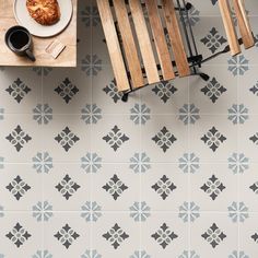 an overhead view of a table and chair with food on it, next to a cutting board