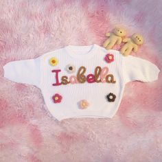 Here, we focus on creating custom and personalized baby/toddler/children's sweaters with a sense of artistic pride. Each sweater is adorned with a baby's name and hand embroidered with rough yarn on the chest. DESCRIPTION: Each sweater proves our meticulous craftsmanship, handmade and hand embroidered on high-quality, ultra soft 100% pure cotton oversized sweaters (carefully designed and crafted by us). Handembroidered baby sweaters are an excellent gift choice for baby showers, newborn/family photos, moon concept photos of babies, birthdays, baptisms, or special events. (If you want to give a personalized gift, a hand embroidered baby sweater is a perfect choice.) Each piece of work is a unique artwork, tailored specifically for you. And become more meaningful. DETAILS: ﹥Material: Cotton White Letter Embroidery Sweater For Winter, Personalized Pink Long Sleeve Sweater, Personalized Pink Crew Neck Sweater, Cute White Letter Print Sweater, Cute White Sweater With Letter Print, Personalized Pink Sweater For Winter, Personalized White Sweater For Winter, Personalized White Cotton Sweater, Customizable Cute Winter Sweater