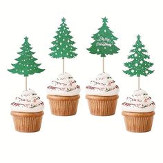 three cupcakes with frosting and christmas trees on top