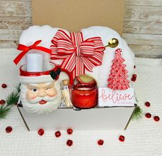 a santa clause christmas basket with candles and decorations