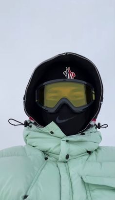 a person wearing ski goggles and a jacket