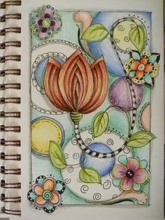 an art journal with flowers and leaves on the pages, in which there is a drawing of