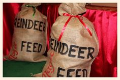 two bags with the words reindeer feed are sitting next to each other in front of a red curtain