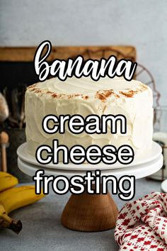 there is a cake with cream cheese frosting on the top and bananas in the background