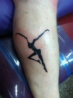 a woman's leg with a tattoo on it that has a silhouette of a dancer