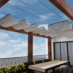 an outdoor dining area with patio furniture and flowers on the table under awnings