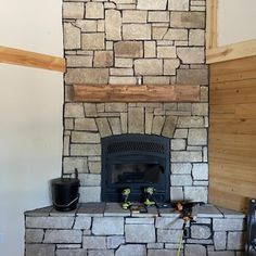 a stone fireplace in the corner of a room