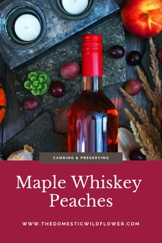 a bottle of maple whiskey next to some apples