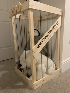 a stuffed animal in a cage that says don't feed the animals on it