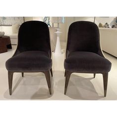 two chairs sitting next to each other in a room