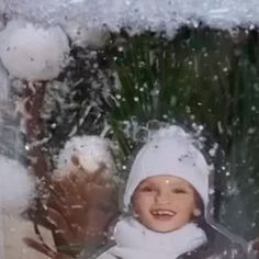 a young child standing outside in the snow