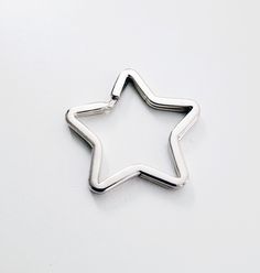 a star shaped metal object on a white surface