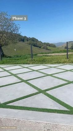 an outdoor area with grass and fence in the background