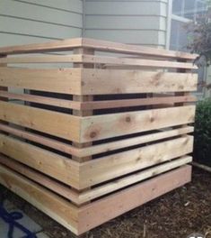 a large wooden box sitting on the side of a house