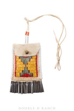 an ornament with fringes and beads hanging from a string on a white background