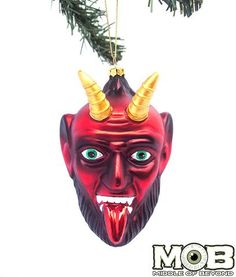 a christmas ornament hanging from a tree with horns on it's head